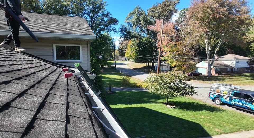 Roof-level view along a gutter at a real Rockland Housewashing job.